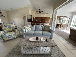 a living room with a couch and a table at Salted Sunset at Punta Gorda Isles in Punta Gorda