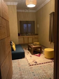 a living room with a couch and a table at Domaine VILLA in Tameslouht