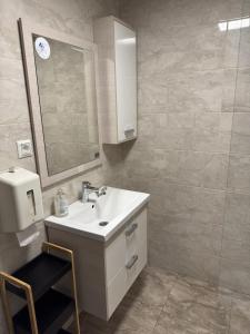 a bathroom with a sink and a mirror at Secret Forest Retreat in Ptujska Gora +16 photos