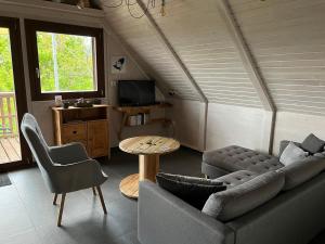 a living room with a couch and a table at Chalet Z en Alsace in Barr