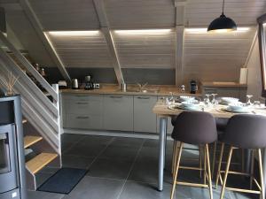 a kitchen with a table and chairs and a staircase at Chalet Z en Alsace in Barr