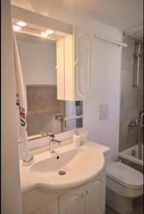 a white bathroom with a sink and a toilet at Trifillianika Traditional House in Trifilliánika +43 photos