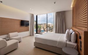 a hotel room with a bed and a tv at Med IL Caesar ADULT ONLY in Zāwiyat al ‘Awwāmah