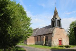 an old brick church with a steeple and a red door at Country house in Erloy, Oise valley in Erloy