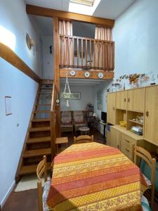 a bedroom with a bed and a staircase in a room at Maison Maubuisson proche du lac de Carcans in Carcans