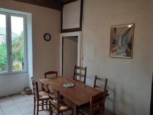 a dining room with a wooden table and chairs at Maison Corbigny in Corbigny