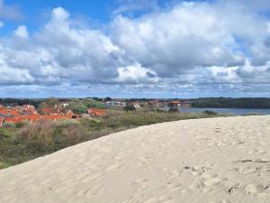a sand hill with a view of a city and a body of water at Vakantiewoning Koestraat 48A met strandcabine in Westkapelle +39 photos