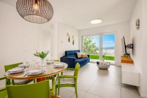 a dining room and living room with a table and chairs at Apartment La Lita Panoramic Sea View Parking Self Checkin in Šmarje