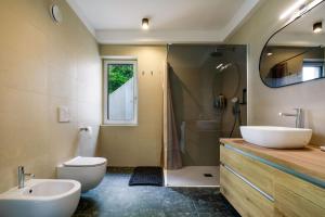 a bathroom with a sink and a toilet and a shower at Apartment La Lita Panoramic Sea View Parking Self Checkin in Šmarje +18 photos