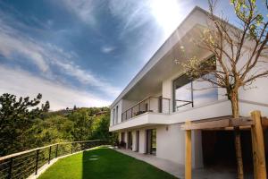 a large white house with a balcony and grass at Apartment La Lita Panoramic Sea View Parking Self Checkin in Šmarje