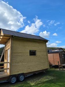 a tiny house on a trailer in a yard at Ardennen Kotje in Durbuy