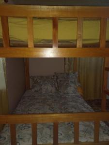 an upper bunk bed in a small room at Cozy Two-bedroom Hot-Cold Water Apartment in Nueva California