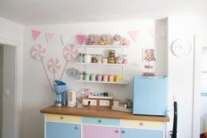 a kitchen with a counter and a blue refrigerator at Buntes Bergglück 1923 in Ober-Gossen
