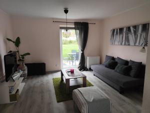 a living room with a couch and a table at Gästehaus Ruhepol in Bissendorf