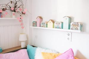 a childs bedroom with a shelf above a bed at Buntes Bergglück 1923 in Ober-Gossen