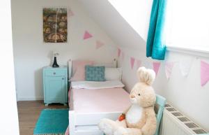 a childs room with a bed and a teddy bear at Buntes Bergglück 1923 in Ober-Gossen +22 photos