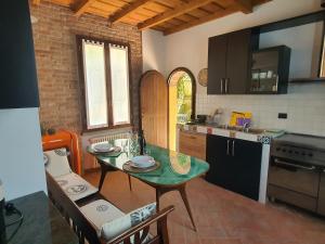 a kitchen with a table and a counter top at Collina del Milanese in San Colombano al Lambro +32 photos