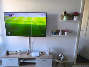 a flat screen tv hanging on a wall at Beau appt vue mer à gammarth in Gammarth