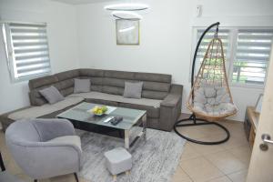 a living room with a couch and a table at Hidden Oasis PeSa - Luxury Villa with Pool & Spa in Podgorica