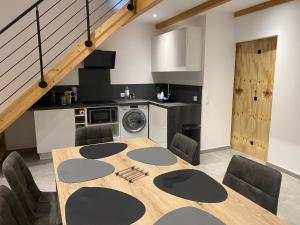 a dining room with a table and chairs and a kitchen at Alata Appartement T3 in Alata +4 photos