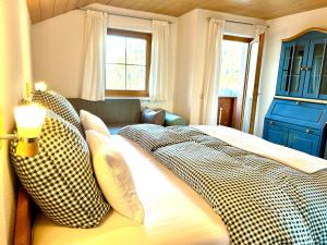 a bedroom with a bed with checkered pillows at Landhaus Berthold in Bürserberg