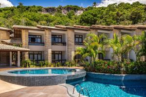 an exterior view of a resort with a swimming pool at Quinta do Sol Praia Hotel in Porto Seguro
