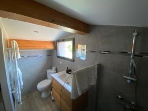 a bathroom with a sink and a toilet at Alata Appartement T3 in Alata