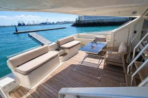 a deck of a boat with a table and chairs at Captain Cangrejo Yacht in Cádiz