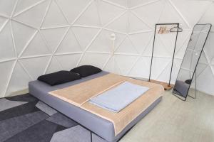 a bed in a room with a white wall at 1000 Stars Riverside Hostel in Ban Khrae Yao Doi Bo +18 photos