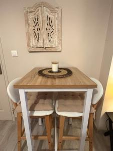 a table with chairs and a cup on top of it at Studio Cosy avec Cour Privée in Fleury +16 photos