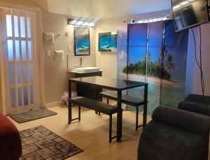 a dining room with a table and a sink at Cocoplum Rest N Hideaway #2 in Nassau