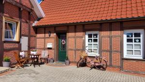 a bicycle parked outside of a building with a green door at Ferienwohnung am Hünenweg in Berge