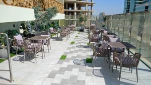 a row of tables and chairs on a patio at LeChateau Boutique Hotel in Jeddah