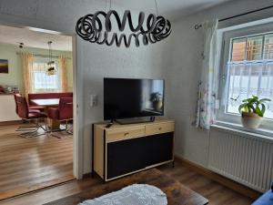 a living room with a flat screen tv on a wall at Dahoam am Silberberg in Bodenmais