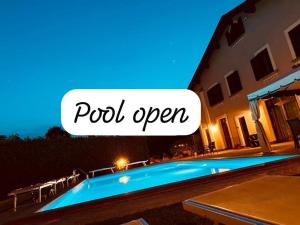 a swimming pool in front of a house at night at Villa Gilda in Bracciano