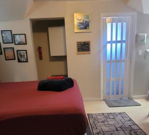 a bedroom with a bed with a red blanket at Cocoplum Rest N Hideaway #2 in Nassau