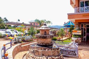 a fountain in the middle of a courtyard at Maya Holiday Point in Ogembo