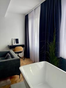 a living room with a couch and a chair at XIX Boutique in Skopje +43 photos