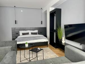 a bedroom with a bed and a living room at XIX Boutique in Skopje