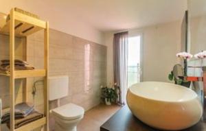 a bathroom with a large oval bath tub in a room at Gorgeous Apartment Garma in Kavran +10 photos