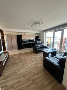 a large living room with a couch and a table at Spacious Apartment with 2 Balconies in Klaipėda