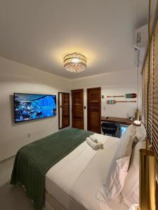 a bedroom with a large bed with a tv on the wall at Pousada Amazing Jeri in Jericoacoara +82 photos