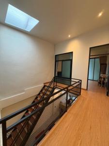 an empty room with a staircase in a house at Casa Yu in Hat Yai
