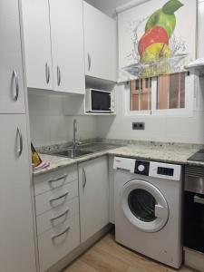 a kitchen with a washing machine and a sink at Dalia Somhome in Peniscola +7 photos