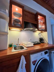 a kitchen with a sink and a washing machine at HYDRA Central House in Hydra