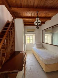 a bedroom with a bed and a wooden ceiling at HYDRA Central House in Hydra