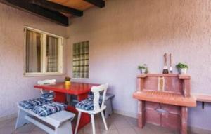 a room with a red table and chairs and a window at Gorgeous Apartment Garma in Kavran