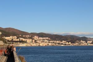 a group of people standing on a bridge over a body of water at Appartamento LUNA in Mele