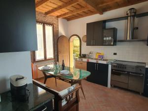a kitchen with a table in the middle of it at Collina del Milanese in San Colombano al Lambro