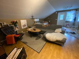 a living room with a couch and a table at Lugnet på landet! in Töllsjö